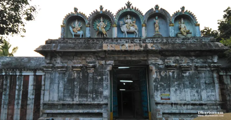 Stone entrance gateway with five painted deity figures in arched niches above the open doorway