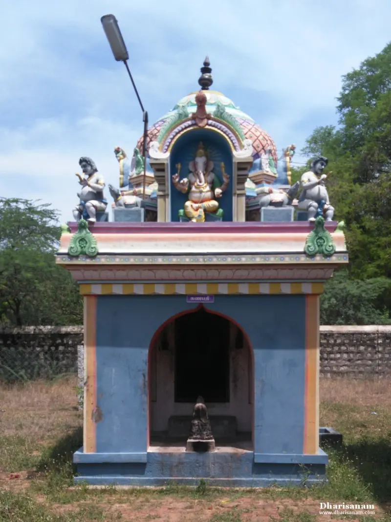 Small blue shrine with an arched doorway and a colourful roof showing a seated figure with attendants