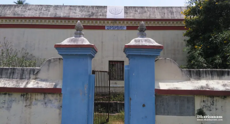 Blue gate pillars before a house with a walled courtyard
