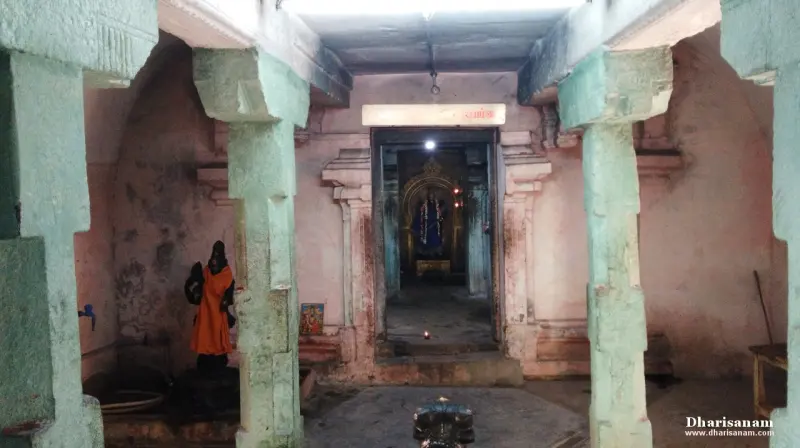 Green stone pillars frame a doorway leading to the sanctum, with a small figure on the left