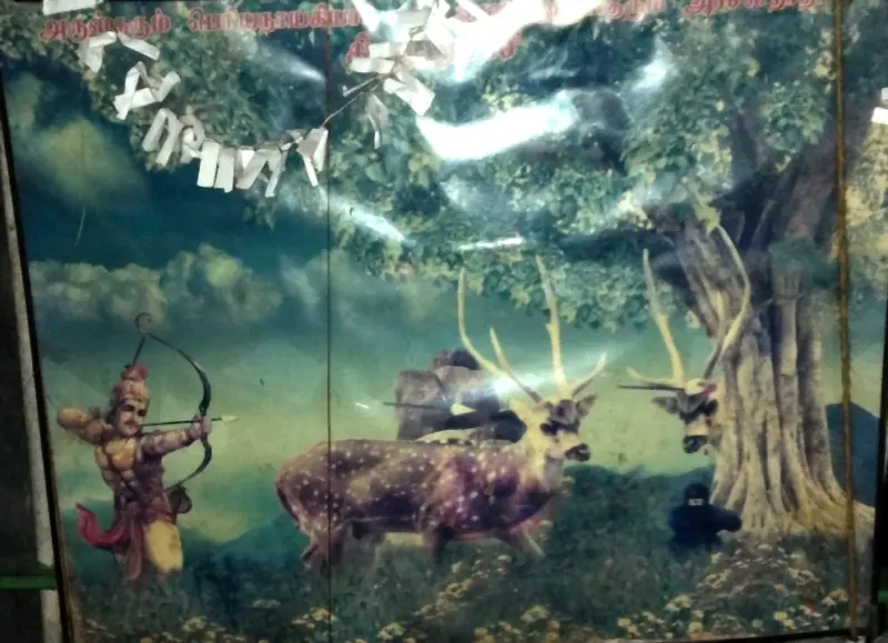 A painting of a king drawing a bow at a spotted deer beneath a large tree, with a second deer and a crouching figure.