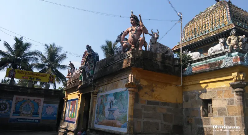 Roof figures and painted panels on yellow shrine walls