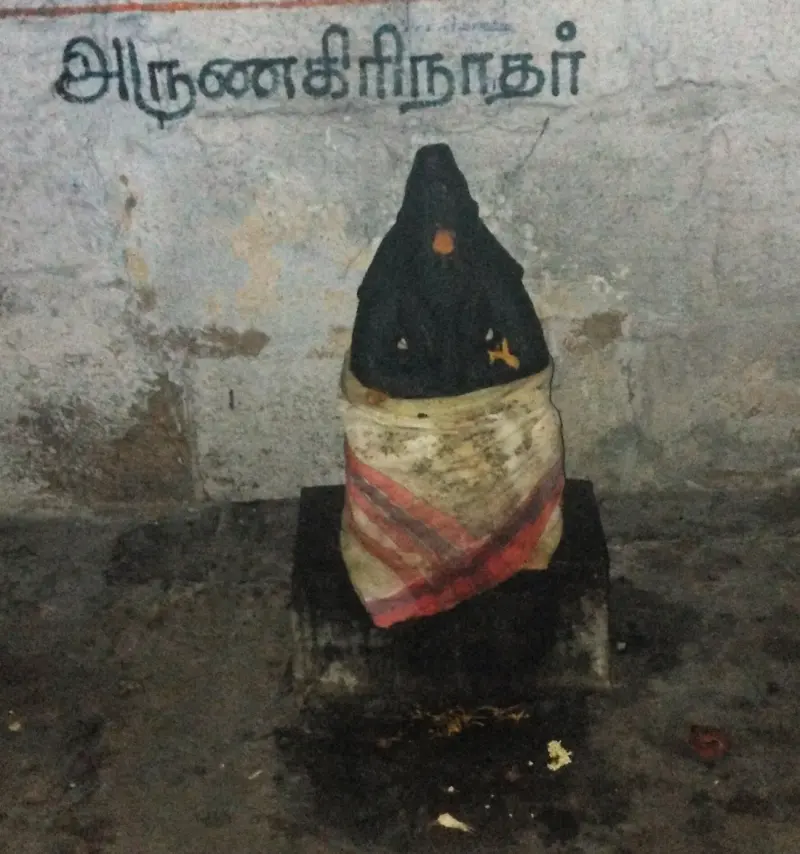 A cloth-draped dark idol under a Tamil label reading Arunagirinathar