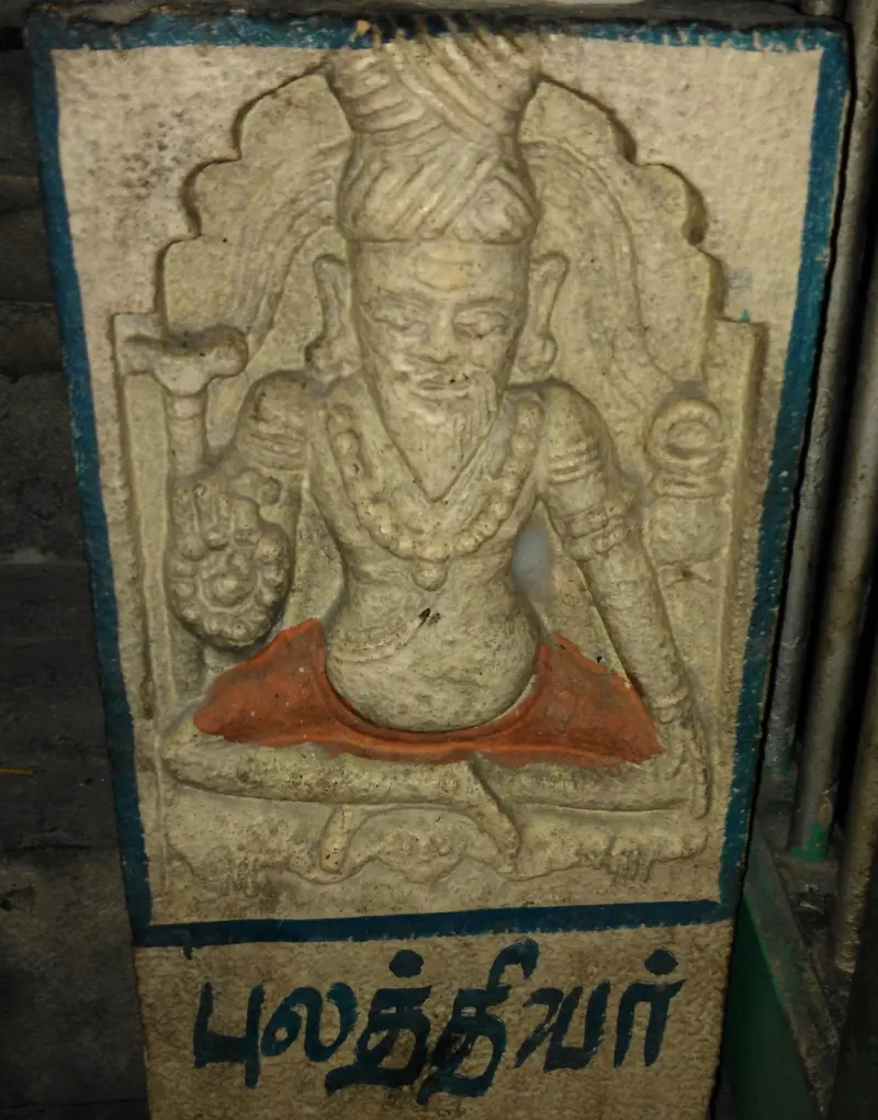 Seated stone sage with beads, named Pulasthiyar in Tamil below