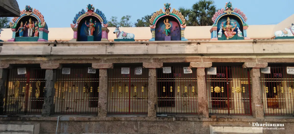 Row of gated shrines with colourful deity sculptures on the roof