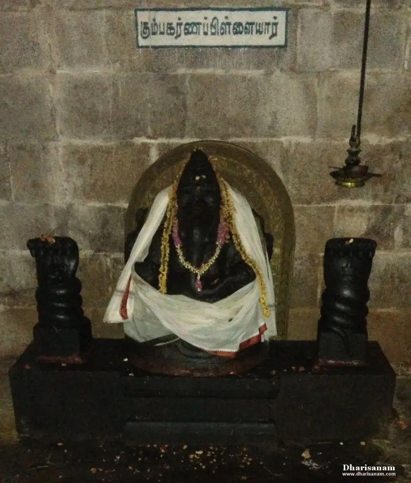 Garlanded black stone Vinayakar idol on a platform, with a Tamil name board above