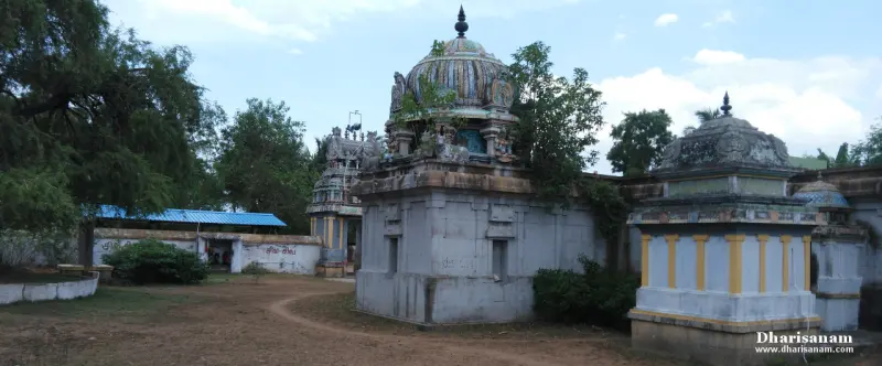 Domed shrine roofs in the courtyard, with the gateway tower and trees behind.