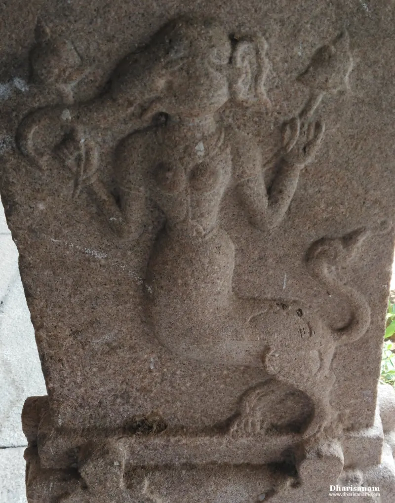 Pillar relief of a female figure with raised hands and a curling tail