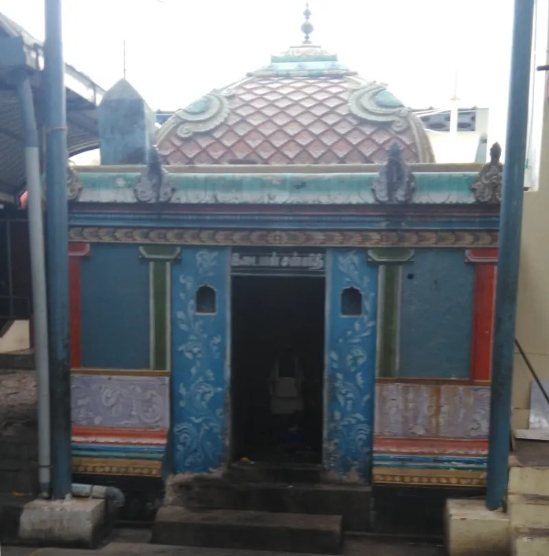A small domed shrine with a blue painted front