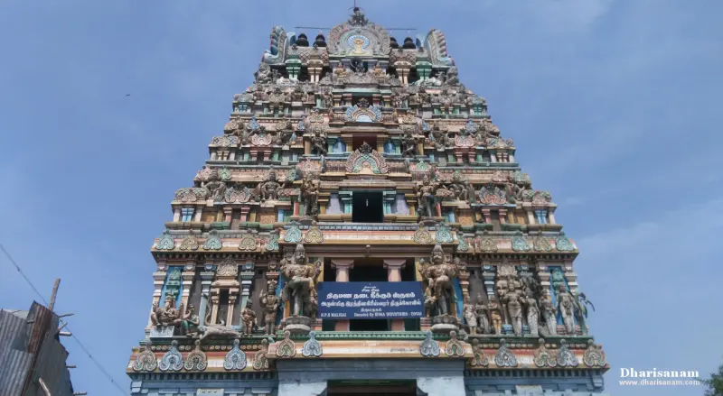 Tiered painted tower with many figures and a Tamil name board above the entrance
