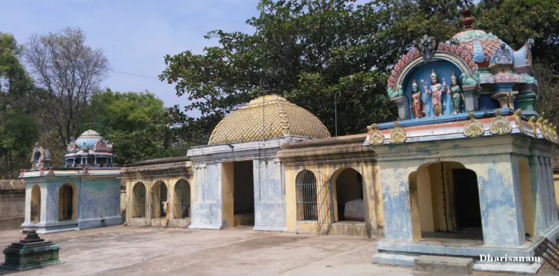 Shrines in a row: a domed one with a yellow lattice pattern, barred windows, and a blue one with painted figures