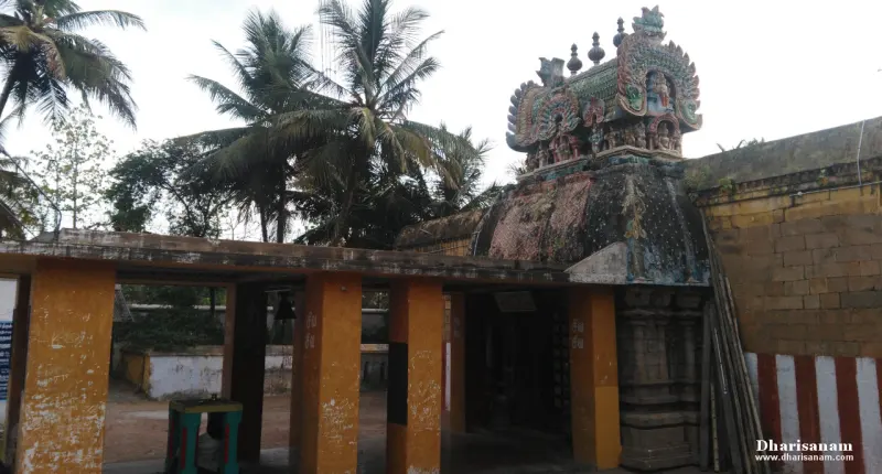 Small shrine doorway under a sculpted dome, flanked by yellow pillars