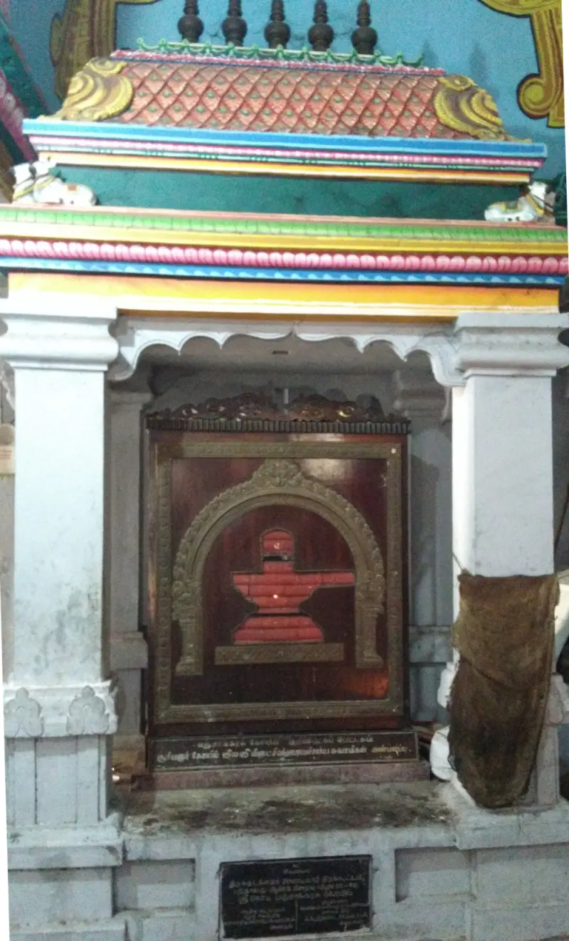Tiny colourful shrine with a red Siva lingam picture