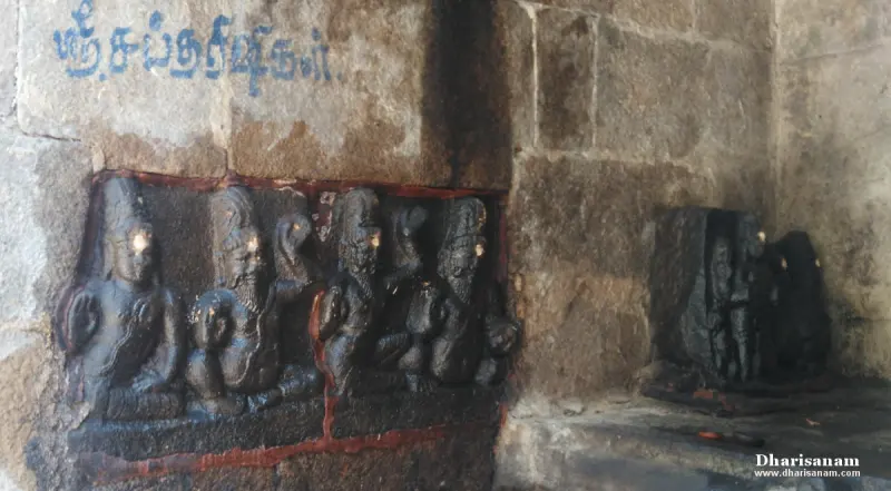 A row of seated rishis carved in dark stone on a wall, with Sri Saptha Rishikal written above