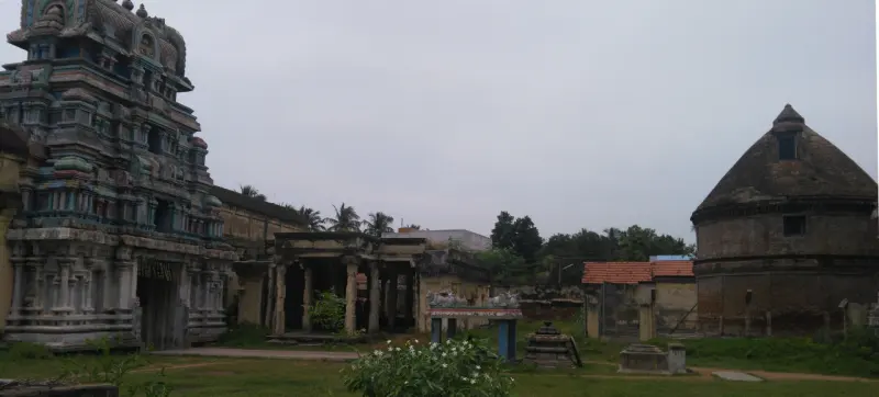 The gopuram on the left and the round conical granary on the right