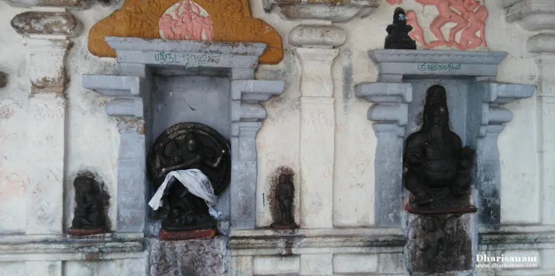Dark stone images in wall niches, with a dancing figure in a round frame at the left