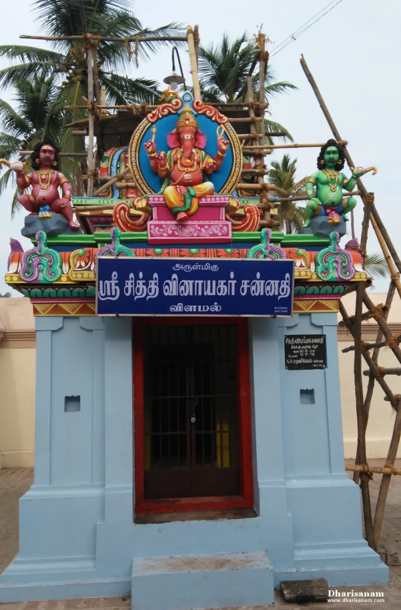 A small blue shrine with a Tamil name board and a painted Vinayakar figure above the door
