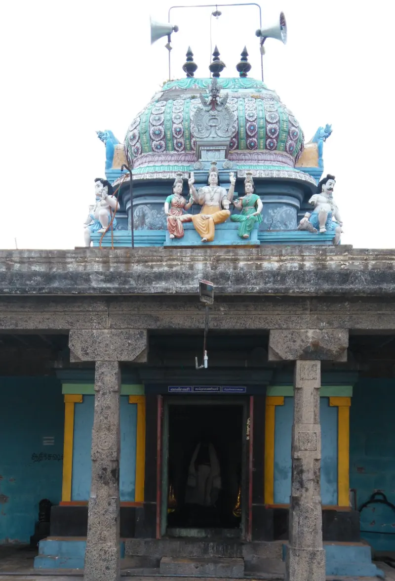 Pillared shrine with a painted dome and seated figures, and a dark inner doorway
