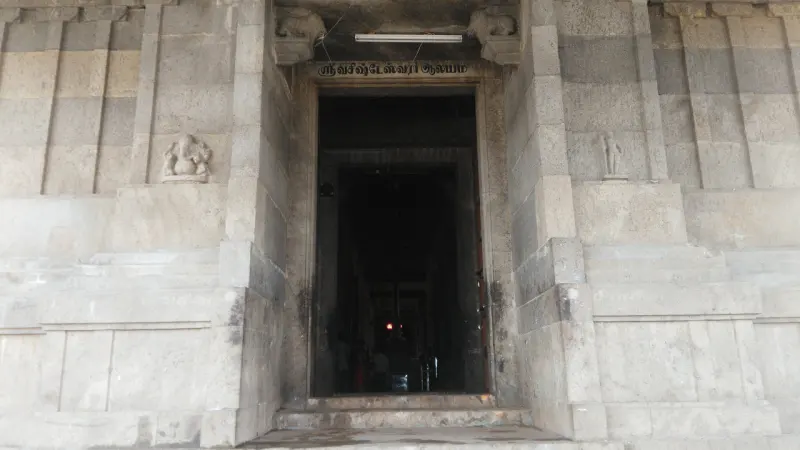 Granite door frame with carved figures and Tamil letters above