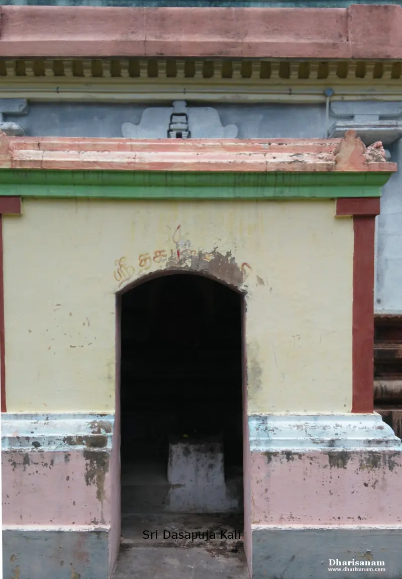 A small yellow shrine with an arched doorway and the words Sri Dasapuja Kali on the picture