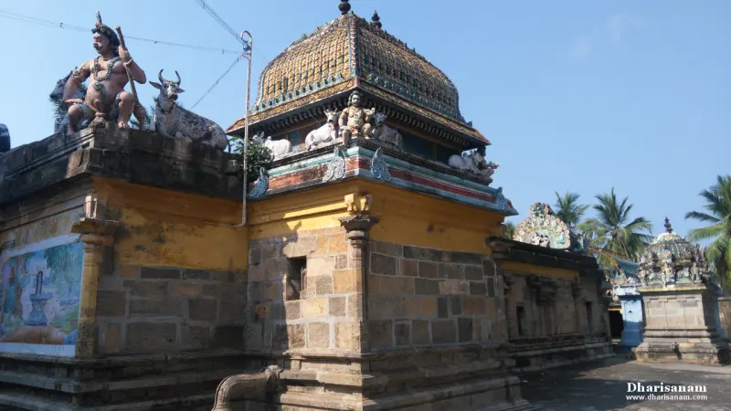 A stone shrine with figures and bulls along its roof