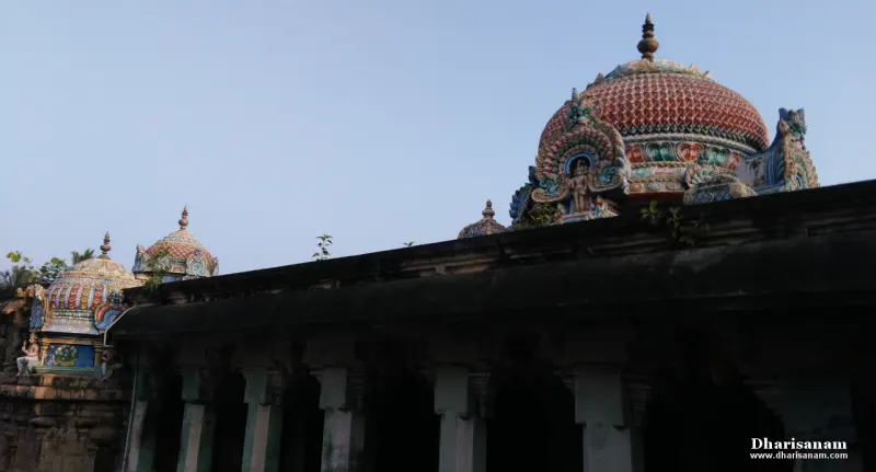 Several domed roofs decorated with painted stucco figures, rising above a dark corridor roof