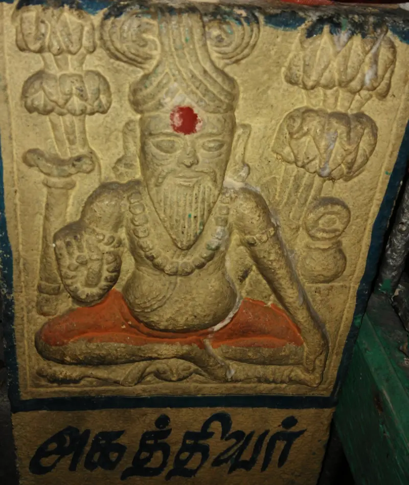 Seated stone sage with beard and beads, named Agathiyar in Tamil below