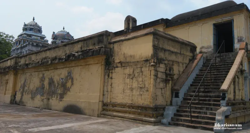 Yellow elevated temple wall with steps and towers rising behind