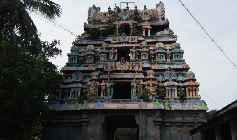A tall colourful three-tier tower covered with stucco figures
