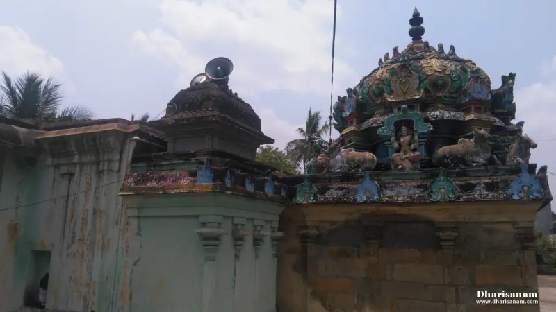 A tower roof with a seated goddess and bull figures, beside a smaller shrine roof.