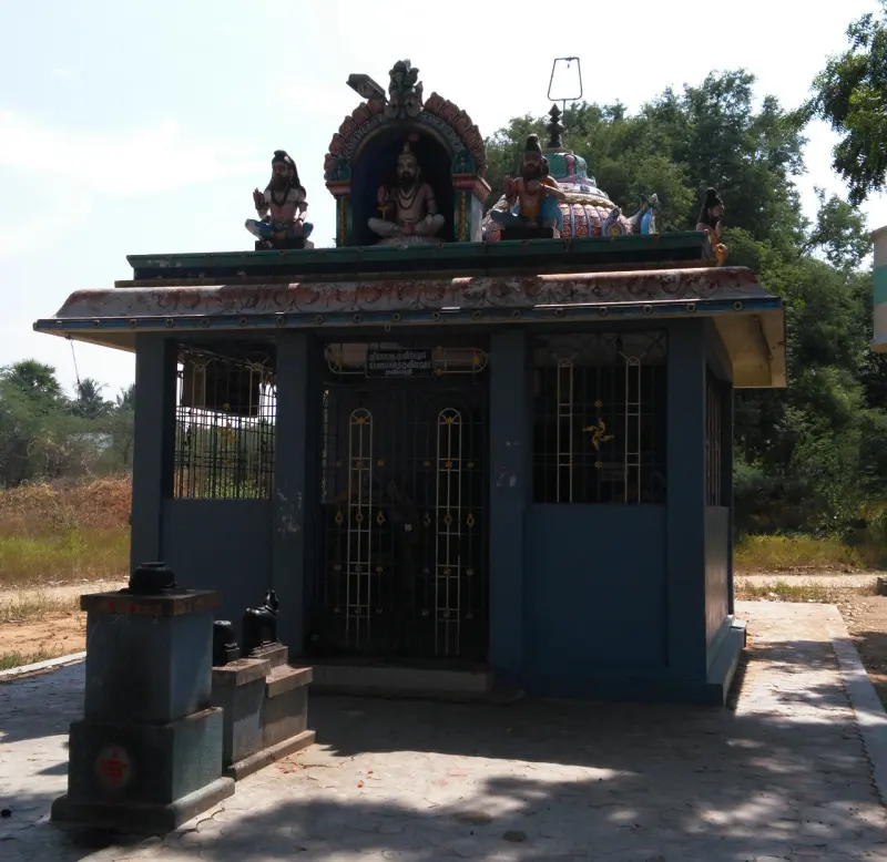 Small blue roadside shrine with colourful statues along its roof
