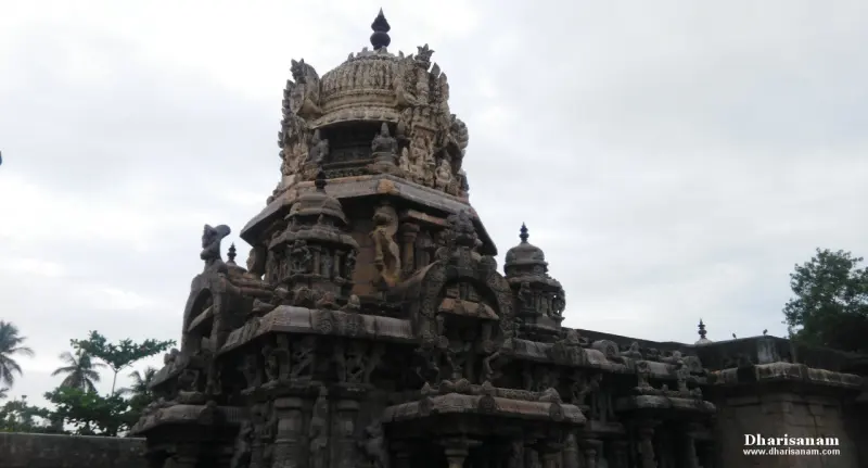 The carved stone tower of the sanctum rising against a cloudy sky, with small towers on its corners.