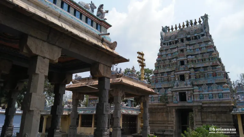 Tiered gopuram on the right, a gilded flag post and pillared halls in the centre