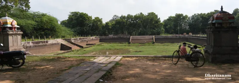 Large stepped tank with corner shrines, a bicycle and a motorbike nearby
