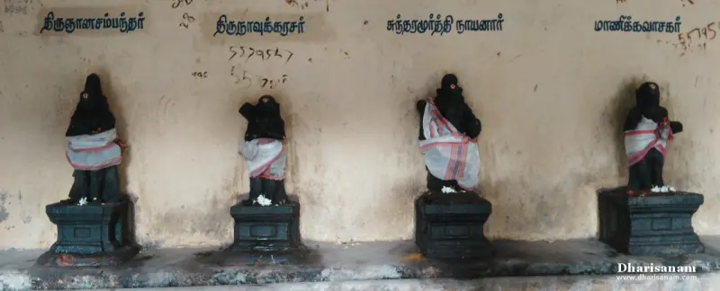 Four draped black idols of the Tamil saints in a row