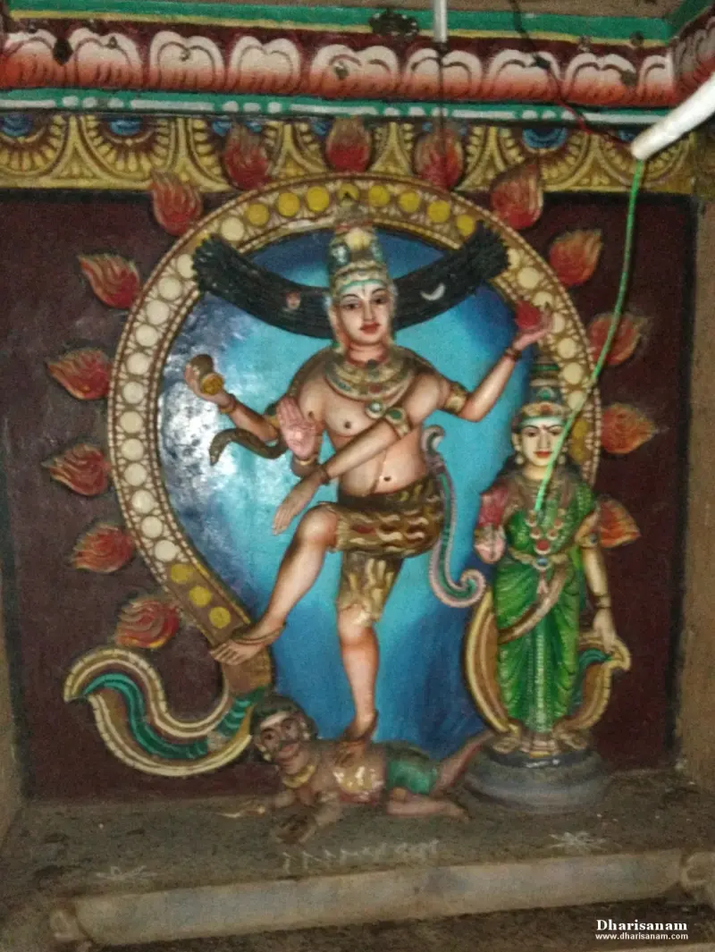 Colourful dancing figure on one raised leg inside a ring, with a standing woman in green at right