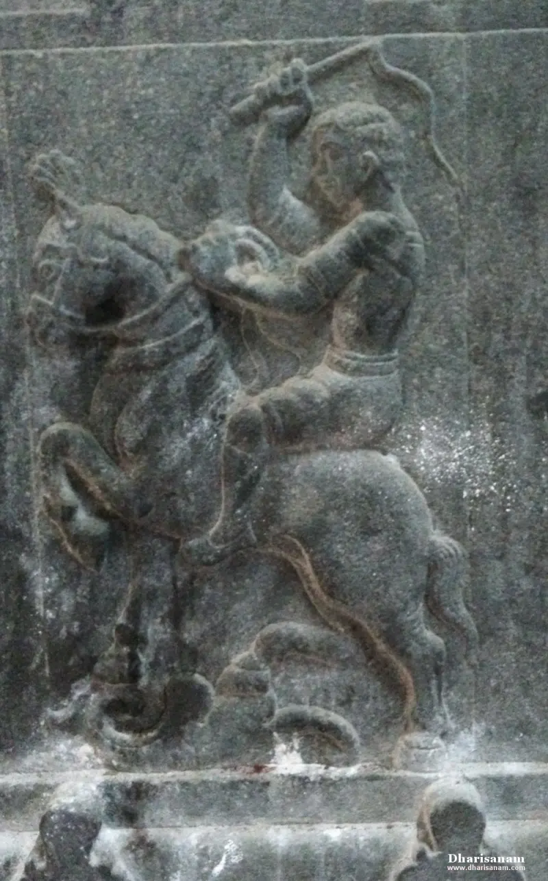 A stone relief of a rider on a rearing horse with one arm raised holding a weapon