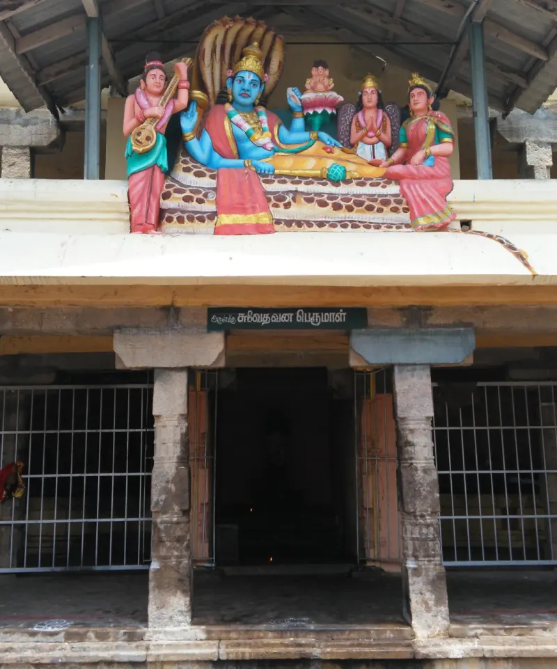 A painted figure of Vishnu reclining on a serpent above a shrine whose sign reads Swethavana Perumal