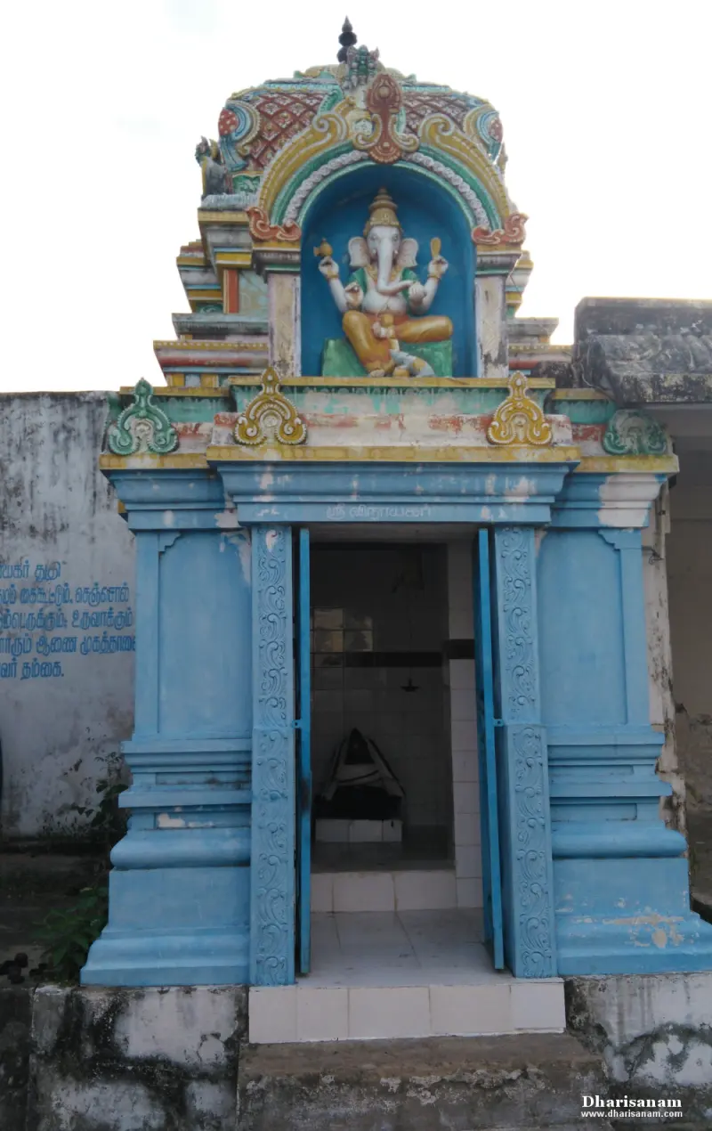 A small blue shrine with a painted Vinayakar sculpture above its open doorway.