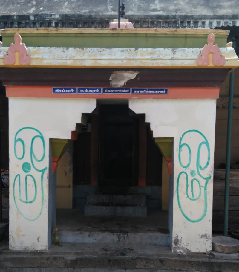 Small open shrine with four blue name boards above the entrance