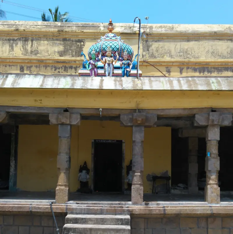 A yellow-walled pillared hall; on its roof a small dome with three painted figures, and a dark doorway below