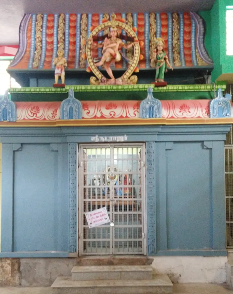 A blue shrine front named Natarajar, with a dancing Shiva figure in a ring of flames above the door.