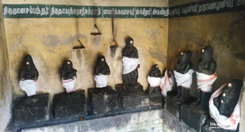 Draped black idols in a row under Tamil name labels