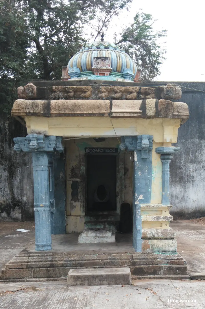 Small shrine with blue pillars and a striped dome, an idol inside