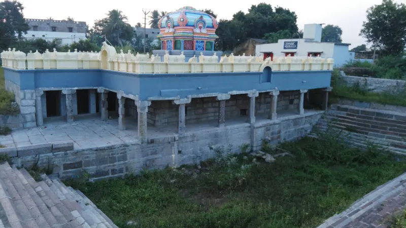 Stepped tank without water around a pillared shrine with painted tower