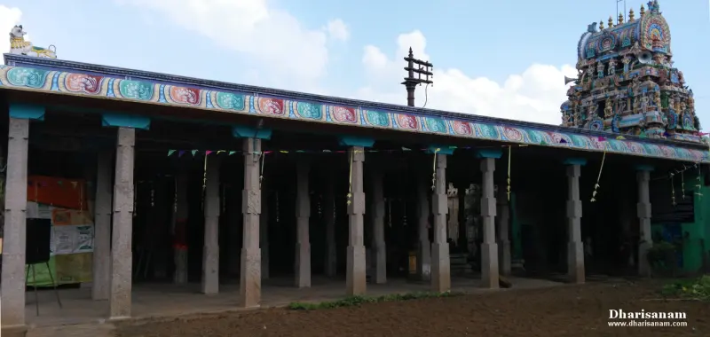 Long corridor of stone pillars with a painted frieze, and a tower at the far end