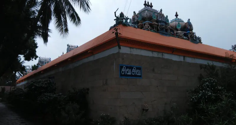 The outer temple wall with the tower rising behind it