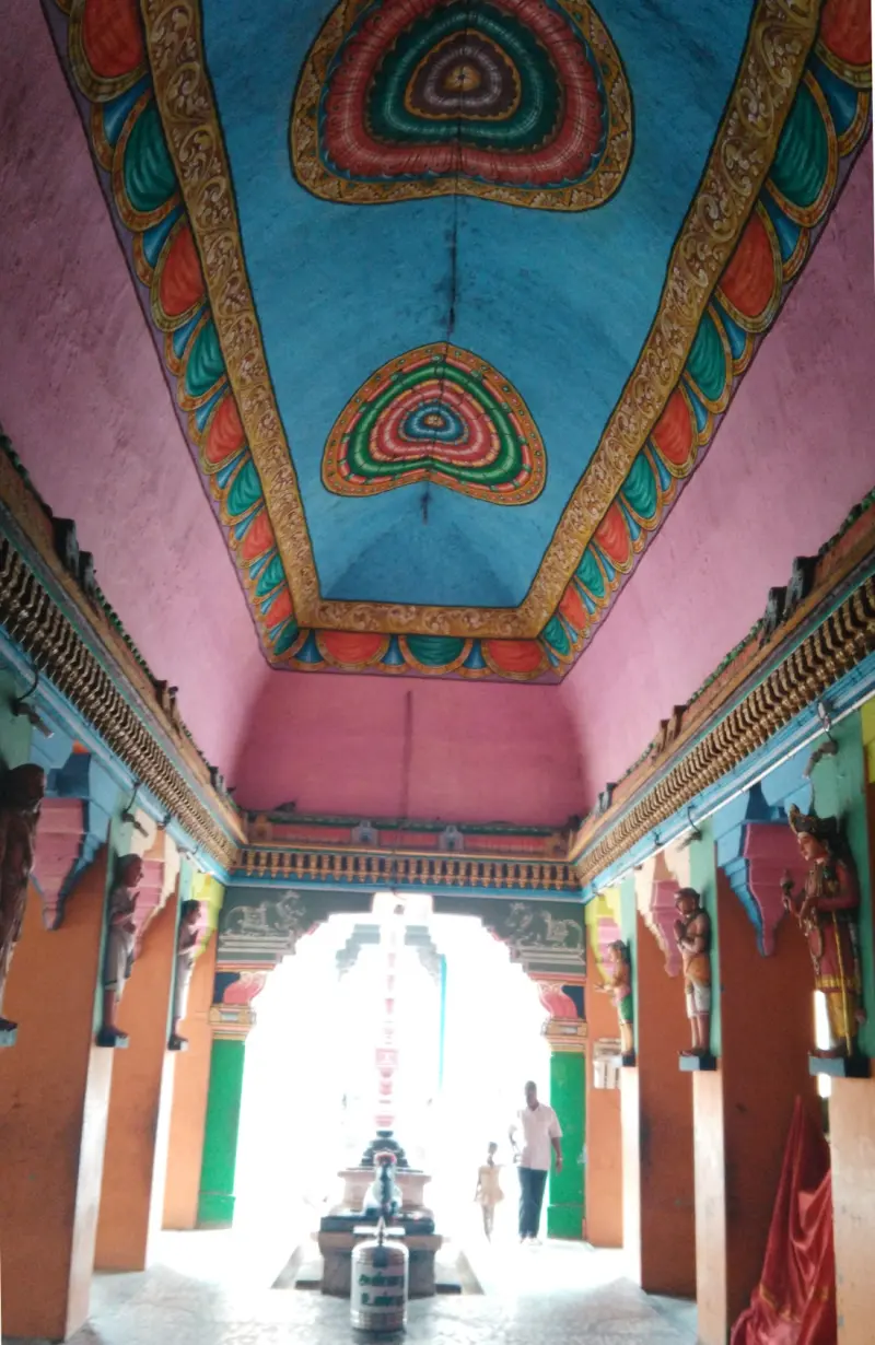 Bright blue and pink ceiling with gods on pillars