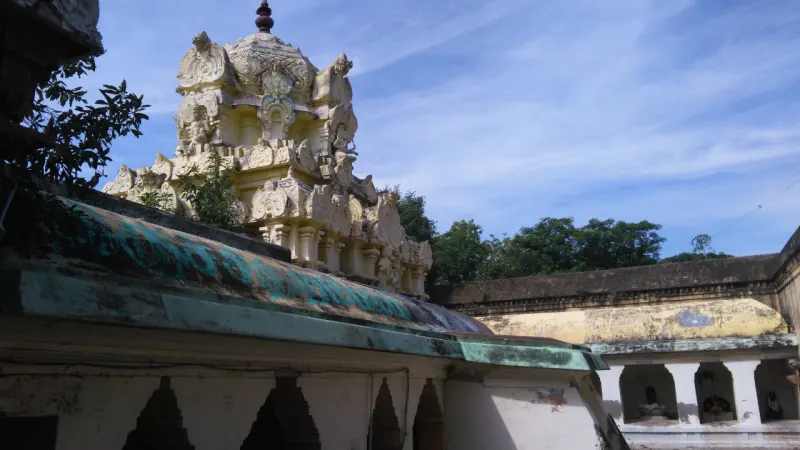 A white sculpted vimana rising above the corridor walls