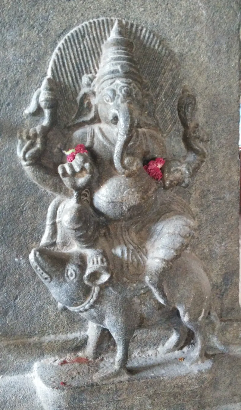 Stone relief of Vinayakar seated on a large mouse